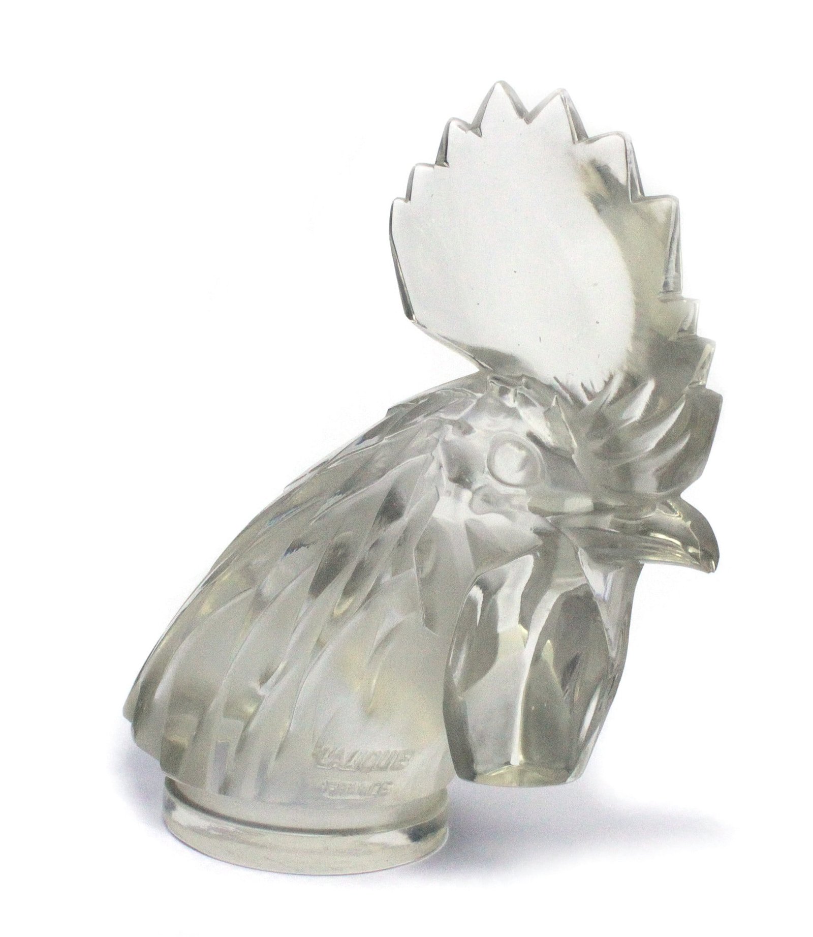 Famous glass car mascot by renowned glassmaker René Lalique. Introduced in 1928 with the name Tête de Coq, this amazing rooster's head in glass is a truly art on wheels. Measures 16cm x 15cm aprox. Very good condition. Large peak on backside of crest seems to have been polished at some point in history, now featuring two peaks. Signed Lalique France in the correct moulded signature.